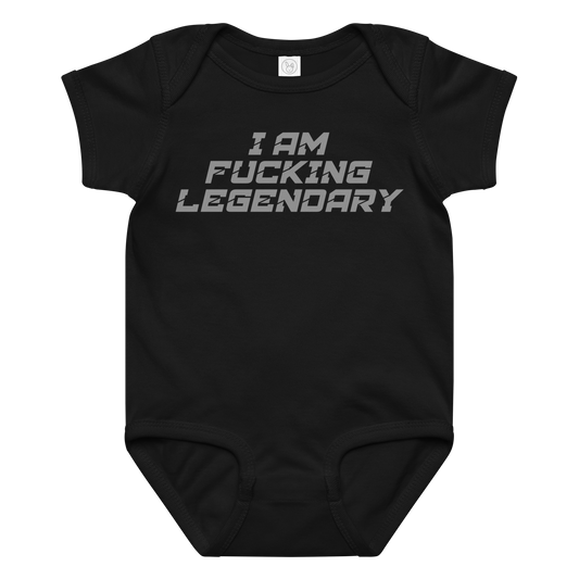 "I Am Fucking Legendary" printed on a black baby jersey bodysuit laying on a flat surface amongst other clothes