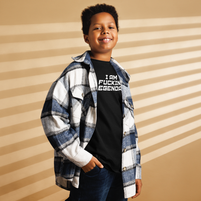 "I Am Fucking Legendary" printed on a black youth classic tee worn by a male also wearing a jacket