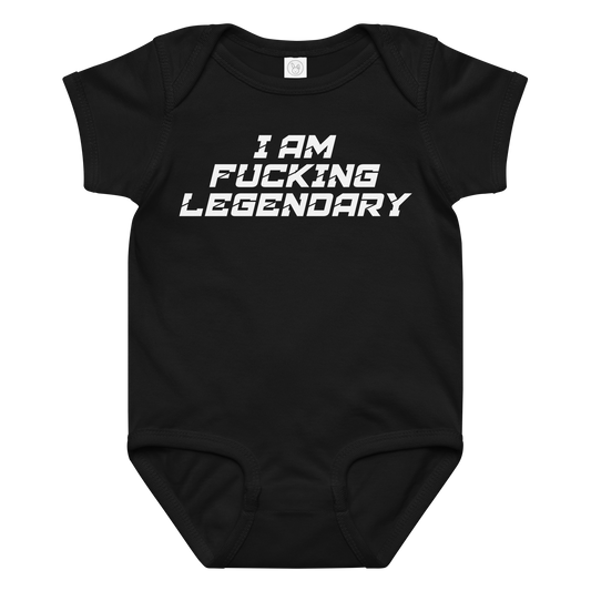 "I Am Fucking Legendary" printed on a black baby jersey bodysuit laying on a flat surface amongst other clothes