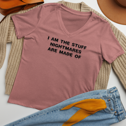 "I am the stuff nightmares are made of" printed on a heather mauve women's relaxed v-neck t-shirt laying on a flat surface amongst other clothes