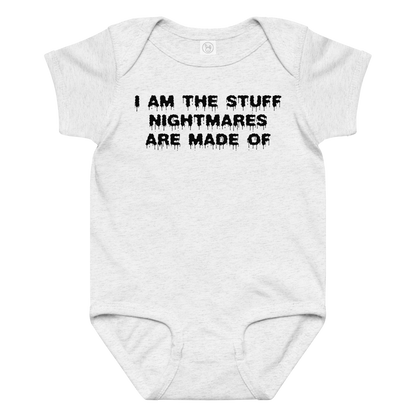 "I am the stuff nightmares are made of" printed on a ash baby jersey bodysuit laying on a flat surface amongst other clothes