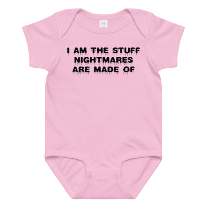 "I am the stuff nightmares are made of" printed on a pink baby jersey bodysuit laying on a flat surface amongst other clothes