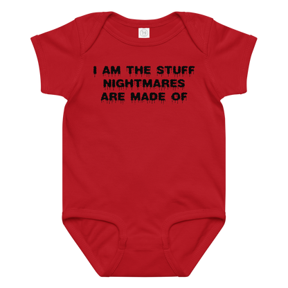 "I am the stuff nightmares are made of" printed on a red baby jersey bodysuit laying on a flat surface amongst other clothes