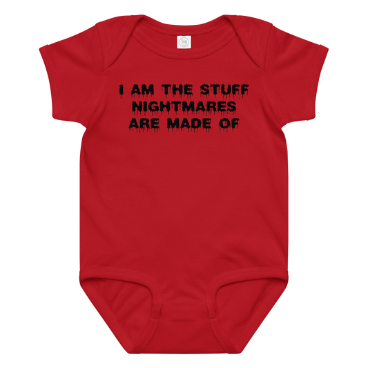 "I am the stuff nightmares are made of" printed on a red baby jersey bodysuit laying on a flat surface amongst other clothes