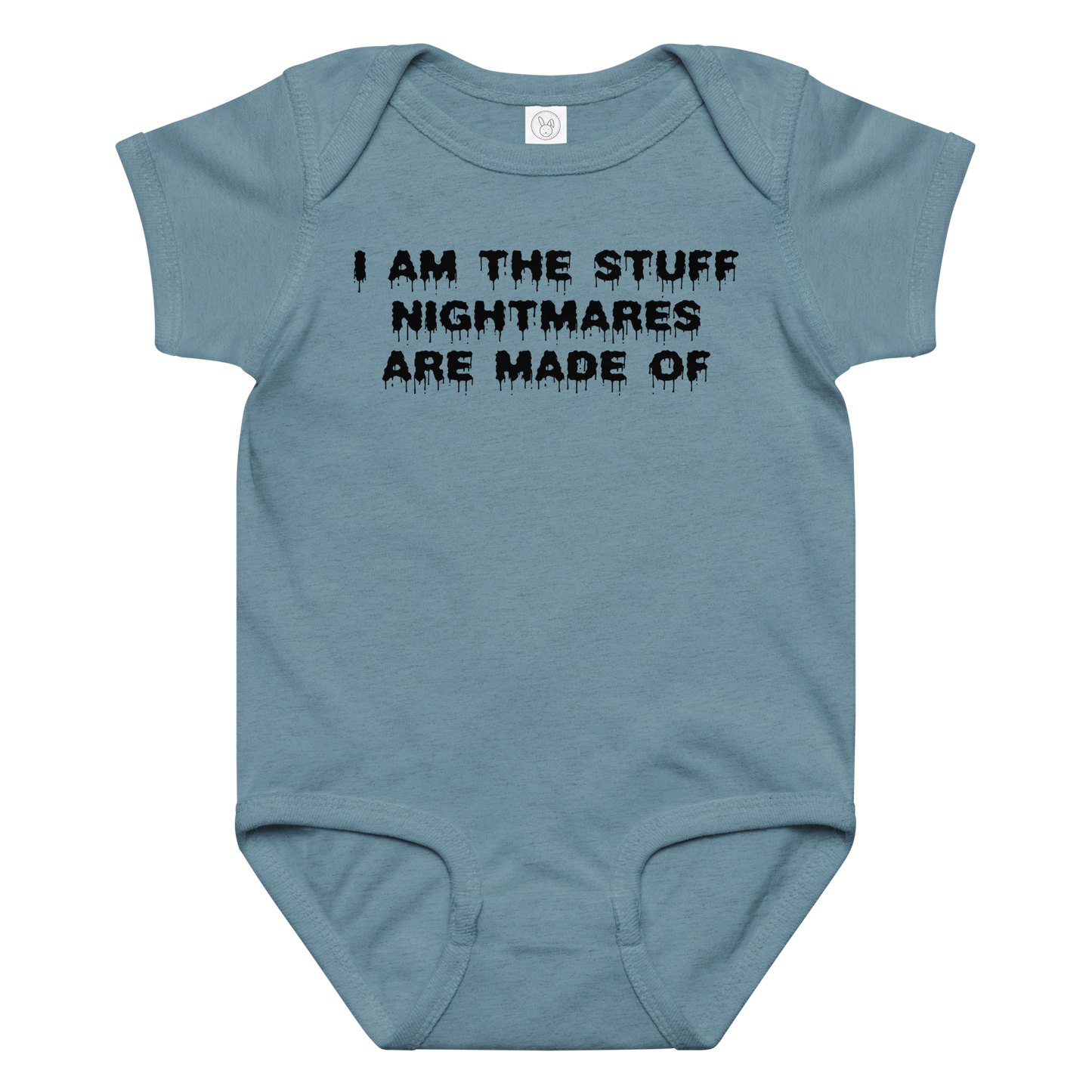"I am the stuff nightmares are made of" printed on a vintage indigo baby jersey bodysuit laying on a flat surface amongst other clothes