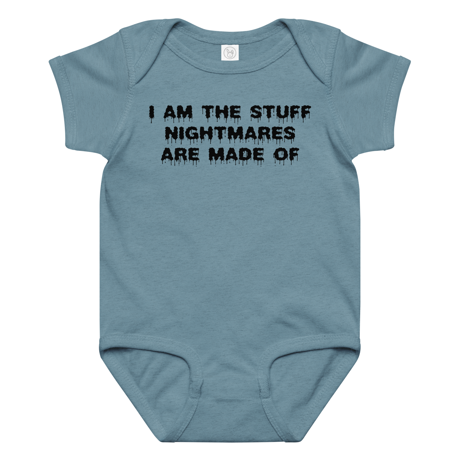 "I am the stuff nightmares are made of" printed on a vintage indigo baby jersey bodysuit laying on a flat surface amongst other clothes