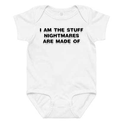 "I am the stuff nightmares are made of" printed on a white baby jersey bodysuit laying on a flat surface amongst other clothes