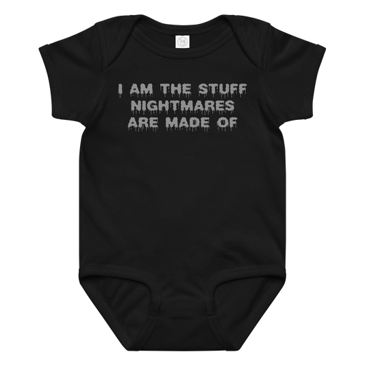 "I am the stuff nightmares are made of" printed on a black baby jersey bodysuit laying on a flat surface amongst other clothes