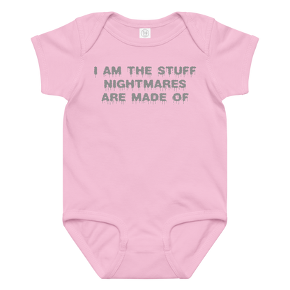 "I am the stuff nightmares are made of" printed on a pink baby jersey bodysuit laying on a flat surface amongst other clothes