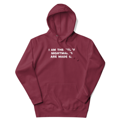 "I am the stuff nightmares are made of" printed on a maroon unisex hoodie laying on a flat surface with the hood up