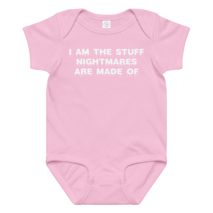 "I am the stuff nightmares are made of" printed on a pink baby jersey bodysuit laying on a flat surface amongst other clothes