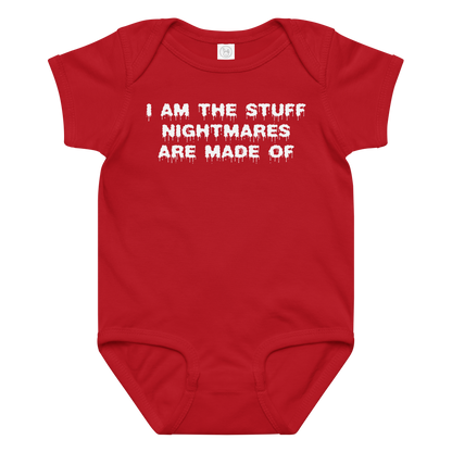 "I am the stuff nightmares are made of" printed on a red baby jersey bodysuit laying on a flat surface amongst other clothes