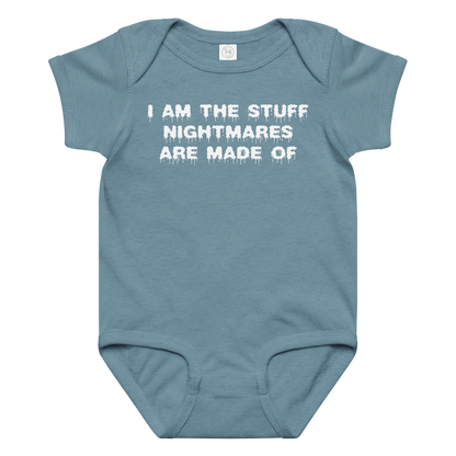 "I am the stuff nightmares are made of" printed on a vintage indigo baby jersey bodysuit laying on a flat surface amongst other clothes