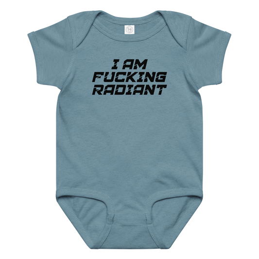 "I Am Fucking Radiant" printed on a vintage indigo baby jersey bodysuit laying on a flat surface amongst other clothes