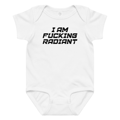 "I Am Fucking Radiant" printed on a white baby jersey bodysuit laying on a flat surface amongst other clothes