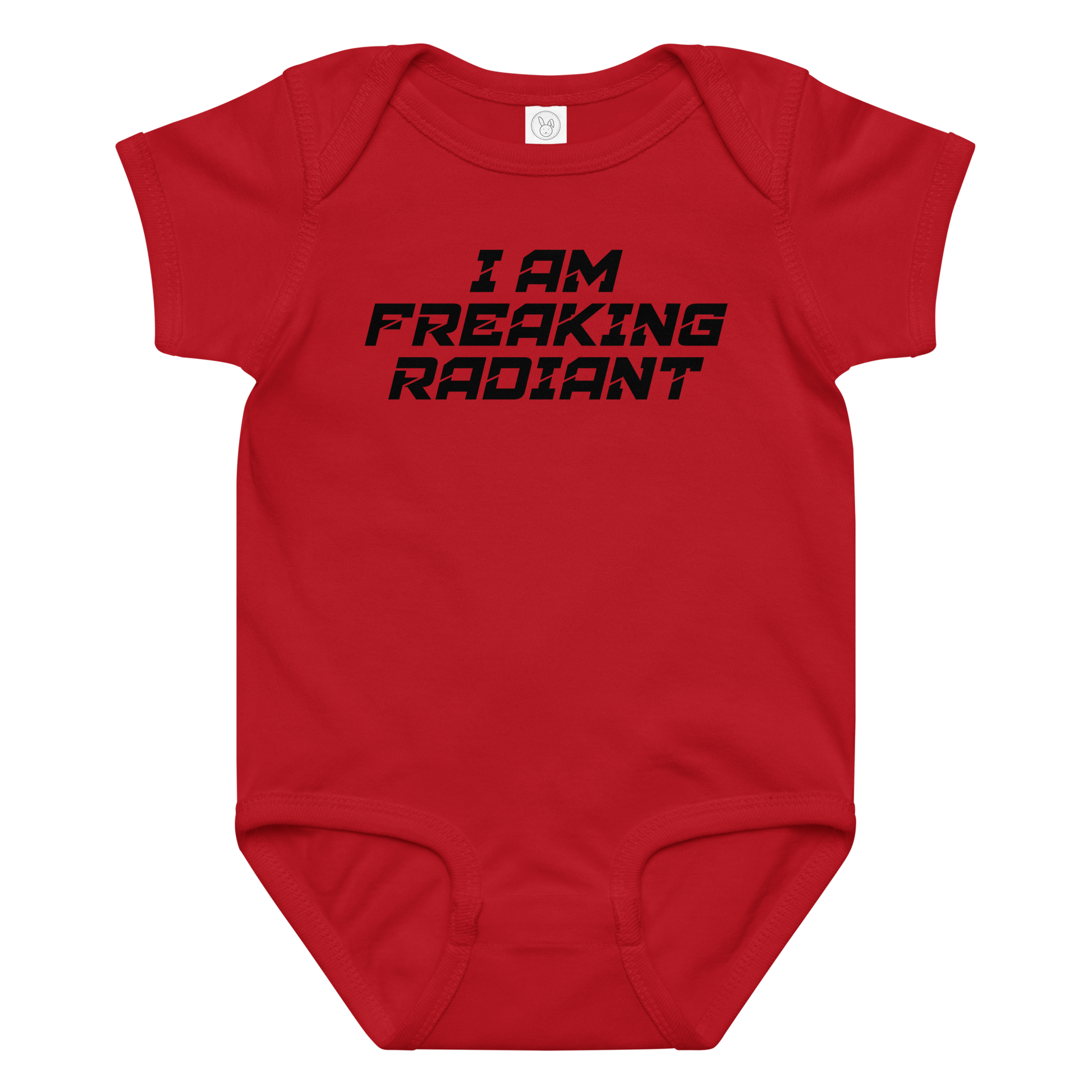 "I Am Freaking Radiant" printed on a red baby jersey bodysuit laying on a flat surface amongst other clothes