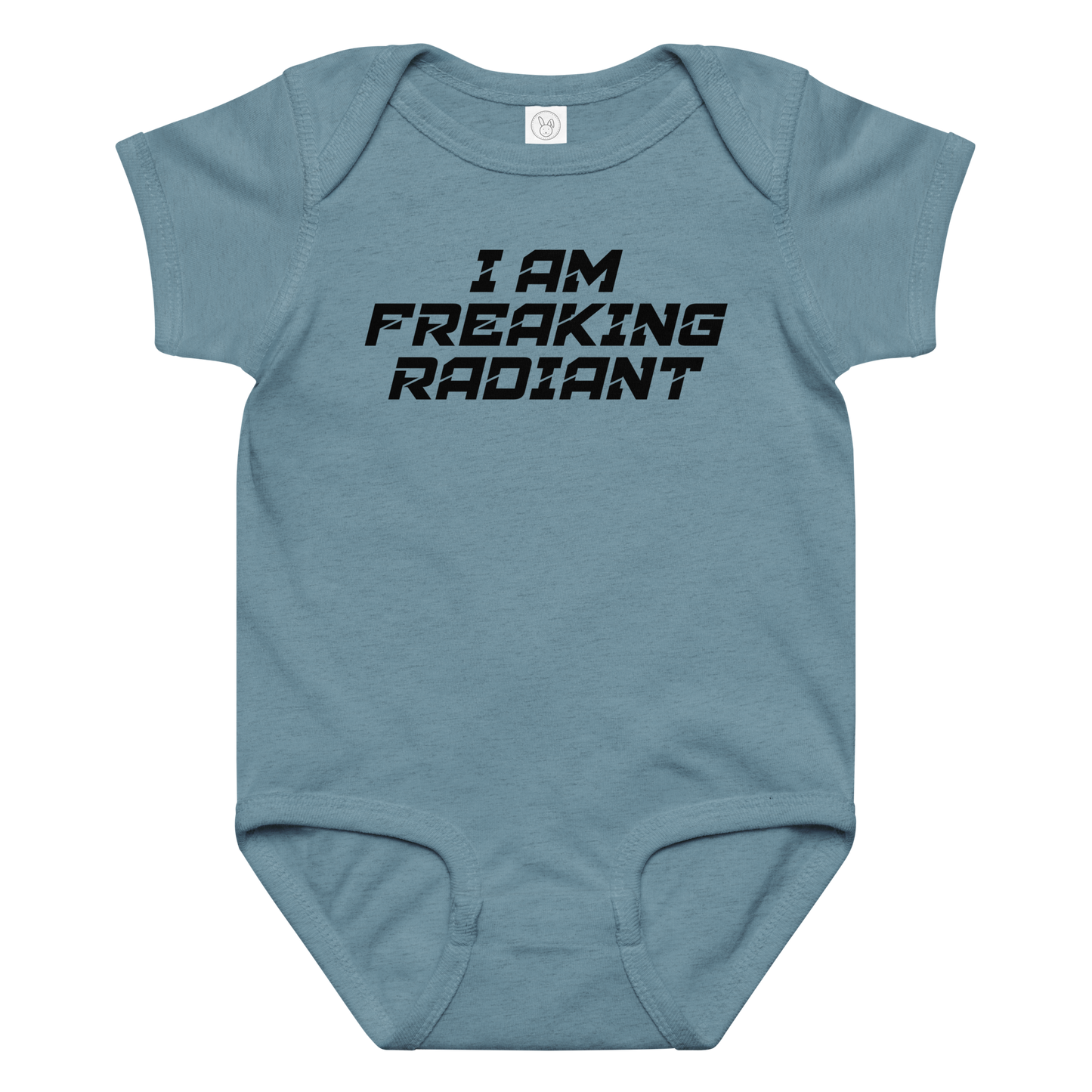 "I Am Freaking Radiant" printed on a vintage indigo baby jersey bodysuit laying on a flat surface amongst other clothes