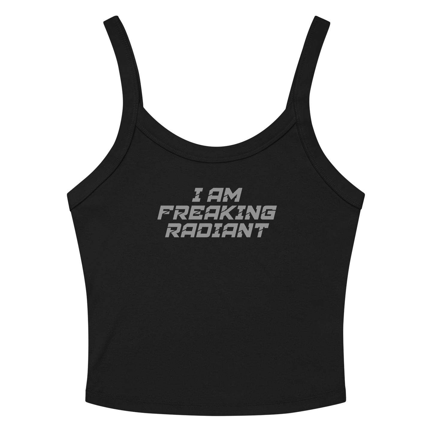 "I Am Freaking Radiant" printed on a solid black blend women's micro-rib tanktop laying on a flat surface amongst sunglasses and shorts