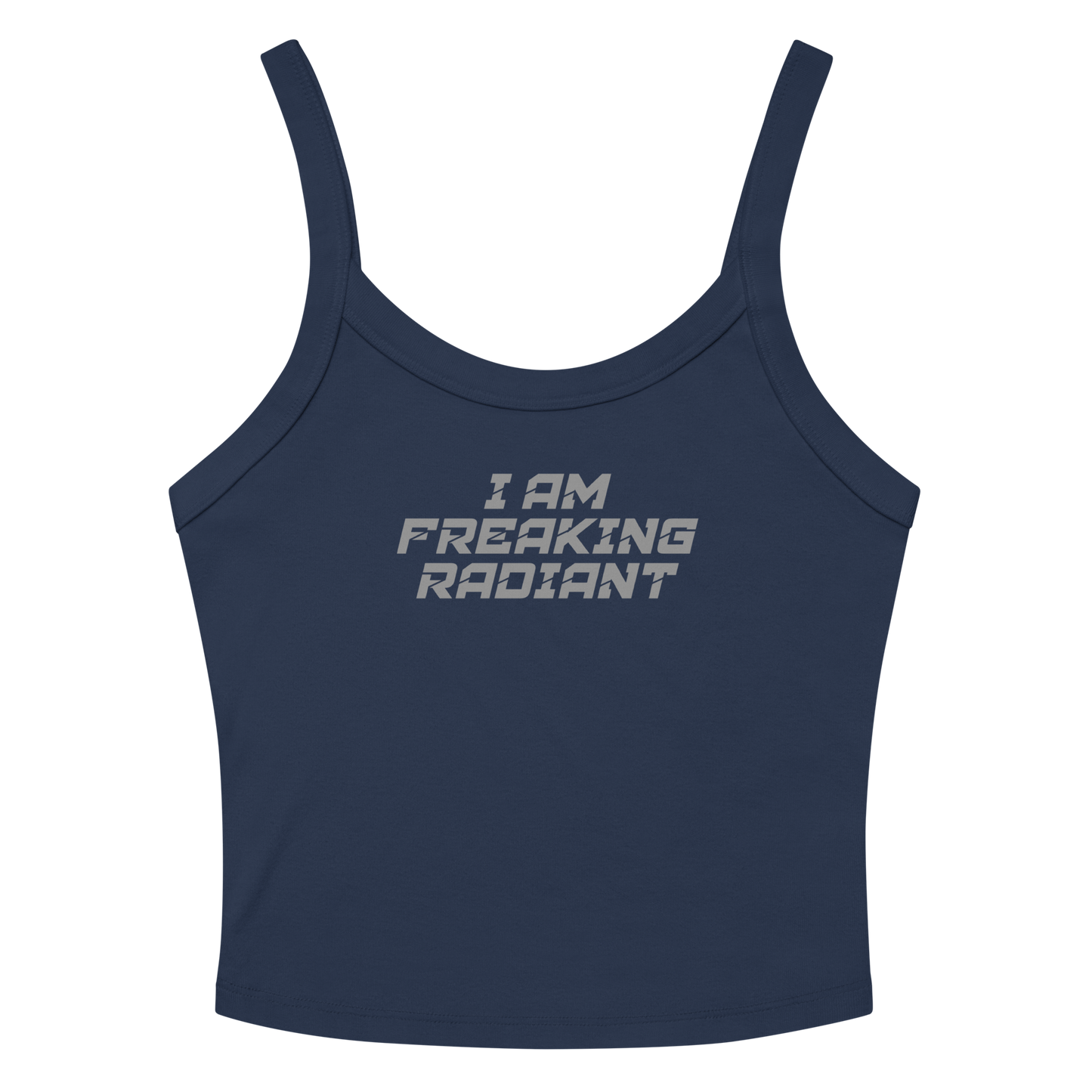 "I Am Freaking Radiant" printed on a solid navy blend women's micro-rib tanktop laying on a flat surface amongst sunglasses and shorts