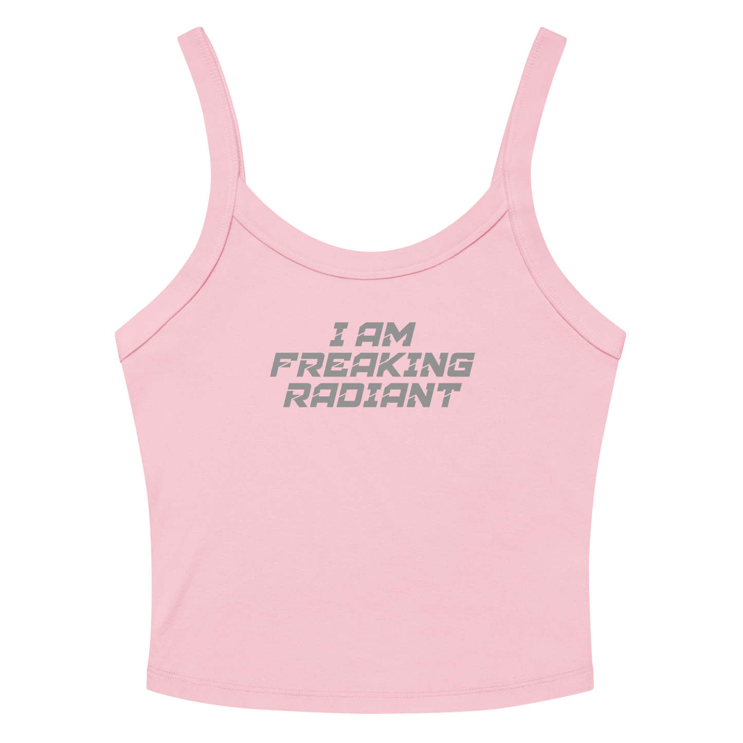 "I Am Freaking Radiant" printed on a solid pink blend women's micro-rib tanktop laying on a flat surface amongst sunglasses and shorts