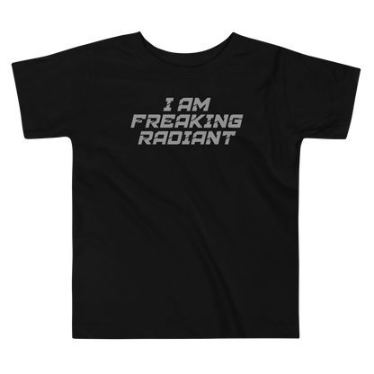 "I Am Freaking Radiant" printed on a black toddler short sleeve tee laying on a flat surface