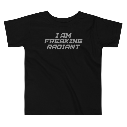 "I Am Freaking Radiant" printed on a black toddler short sleeve tee laying on a flat surface