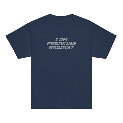 "I Am Freaking Radiant" printed on a navy youth classic tee laying on a flat surface