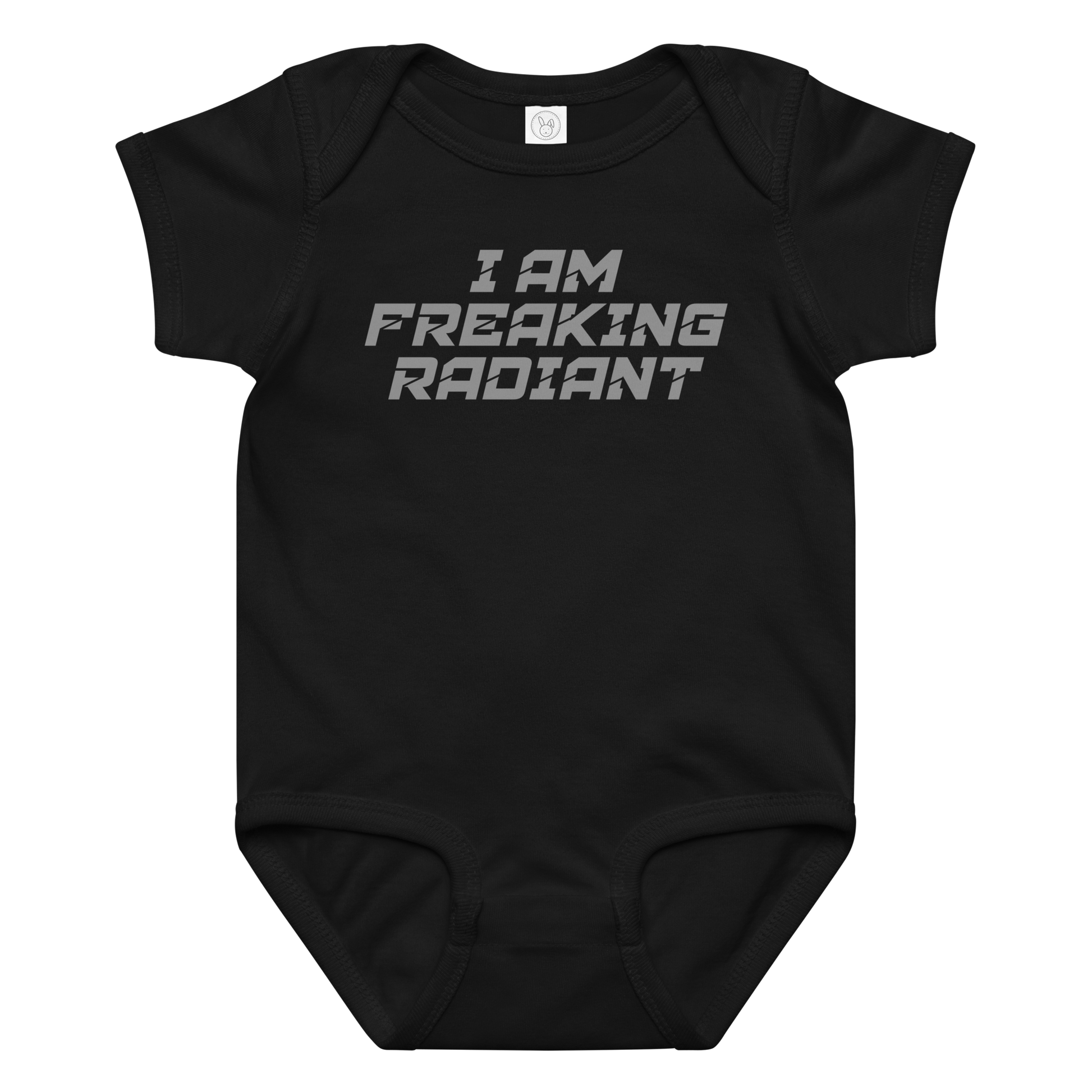 "I Am Freaking Radiant" printed on a black baby jersey bodysuit laying on a flat surface amongst other clothes