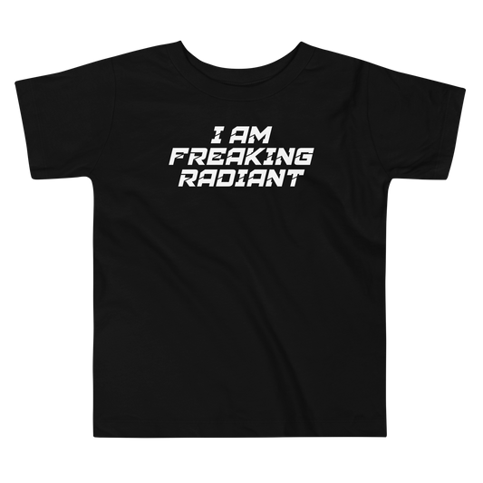 "I Am Freaking Radiant" printed on a black toddler short sleeve tee laying on a flat surface