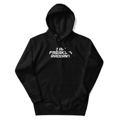 "I Am Freaking Radiant" printed on a black unisex hoodie laying on a flat surface with the hood up