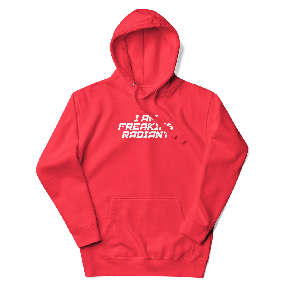 "I Am Freaking Radiant" printed on a team red unisex hoodie laying on a flat surface with the hood up