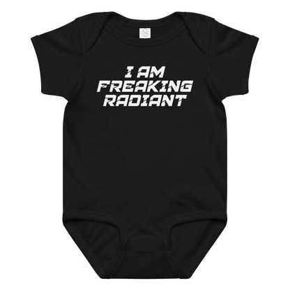 "I Am Freaking Radiant" printed on a black baby jersey bodysuit laying on a flat surface amongst other clothes