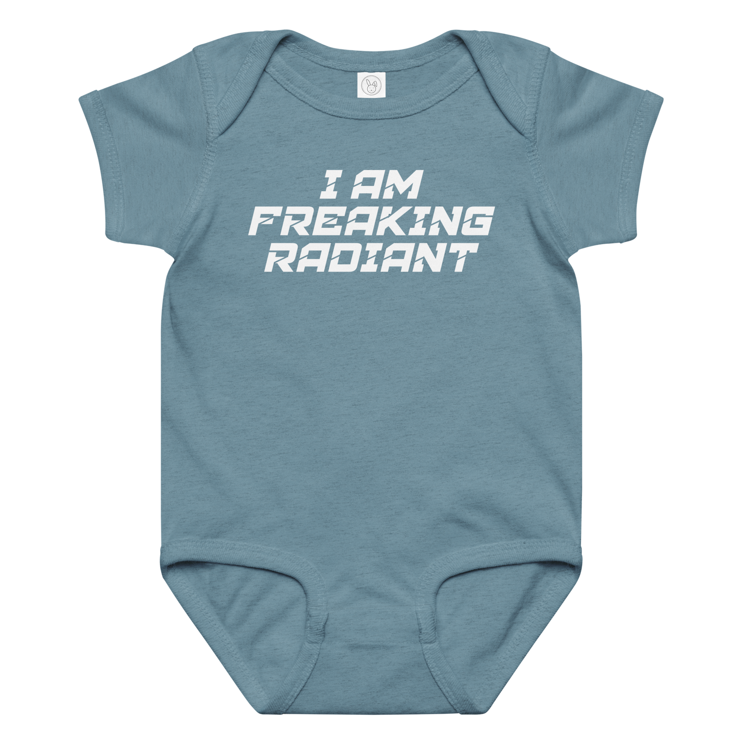 "I Am Freaking Radiant" printed on a vintage indigo baby jersey bodysuit laying on a flat surface amongst other clothes