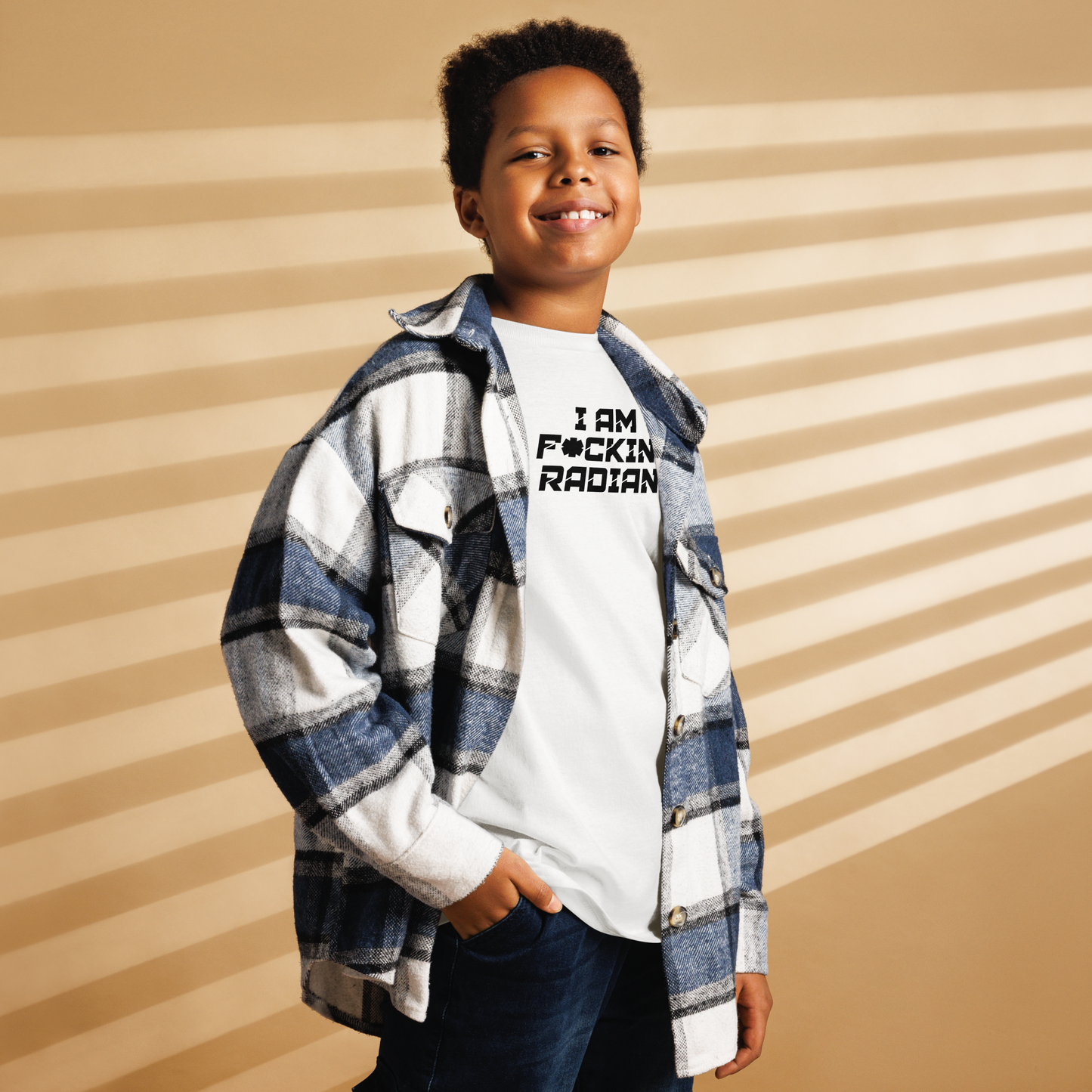 "I Am F*cking Radiant" printed on a white youth classic tee worn by a male also wearing a jacket