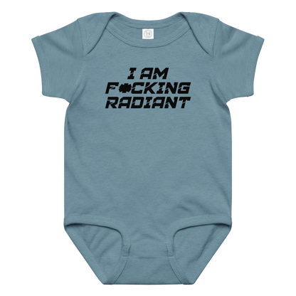 "I Am F*cking Radiant" printed on a vintage indigo baby jersey bodysuit laying on a flat surface amongst other clothes