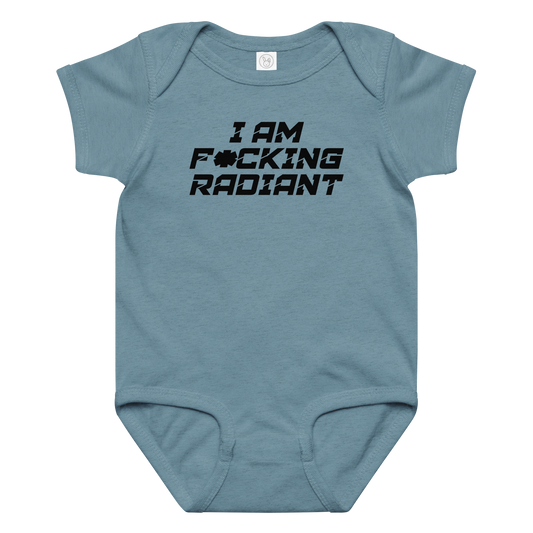 "I Am F*cking Radiant" printed on a vintage indigo baby jersey bodysuit laying on a flat surface amongst other clothes