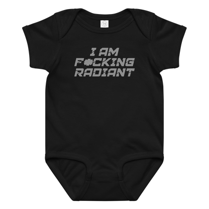 "I Am F*cking Radiant" printed on a black baby jersey bodysuit laying on a flat surface amongst other clothes