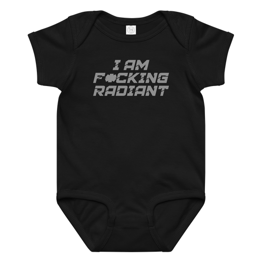 "I Am F*cking Radiant" printed on a black baby jersey bodysuit laying on a flat surface amongst other clothes