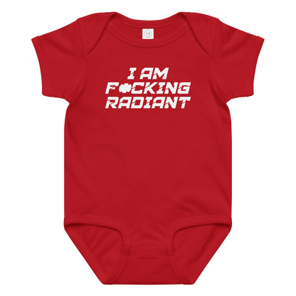 "I Am F*cking Radiant" printed on a red baby jersey bodysuit laying on a flat surface amongst other clothes