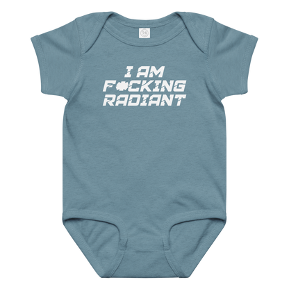 "I Am F*cking Radiant" printed on a vintage indigo baby jersey bodysuit laying on a flat surface amongst other clothes
