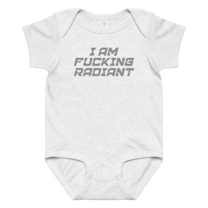 "I Am Fucking Radiant" printed on a ash baby jersey bodysuit laying on a flat surface amongst other clothes