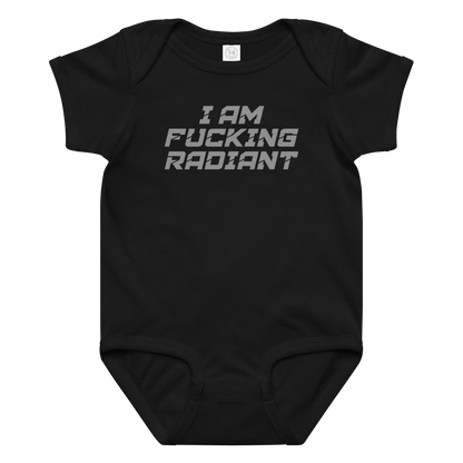 "I Am Fucking Radiant" printed on a black baby jersey bodysuit laying on a flat surface amongst other clothes