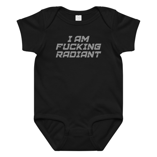 "I Am Fucking Radiant" printed on a black baby jersey bodysuit laying on a flat surface amongst other clothes