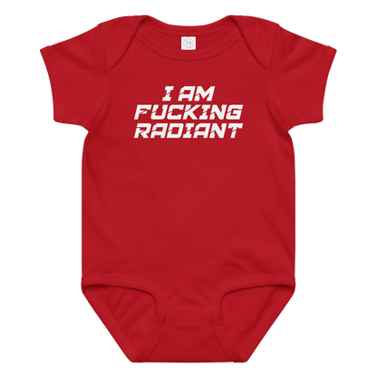 "I Am Fucking Radiant" printed on a red baby jersey bodysuit laying on a flat surface amongst other clothes