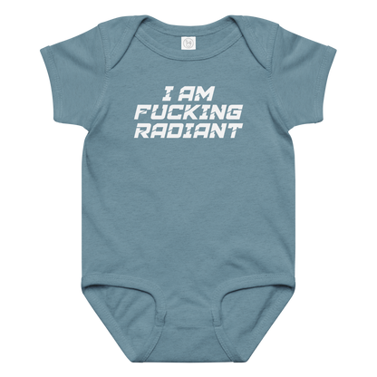 "I Am Fucking Radiant" printed on a vintage indigo baby jersey bodysuit laying on a flat surface amongst other clothes