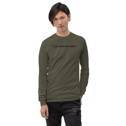 "I am remarkable" printed on a military green men's long sleeve shirt worn by a male