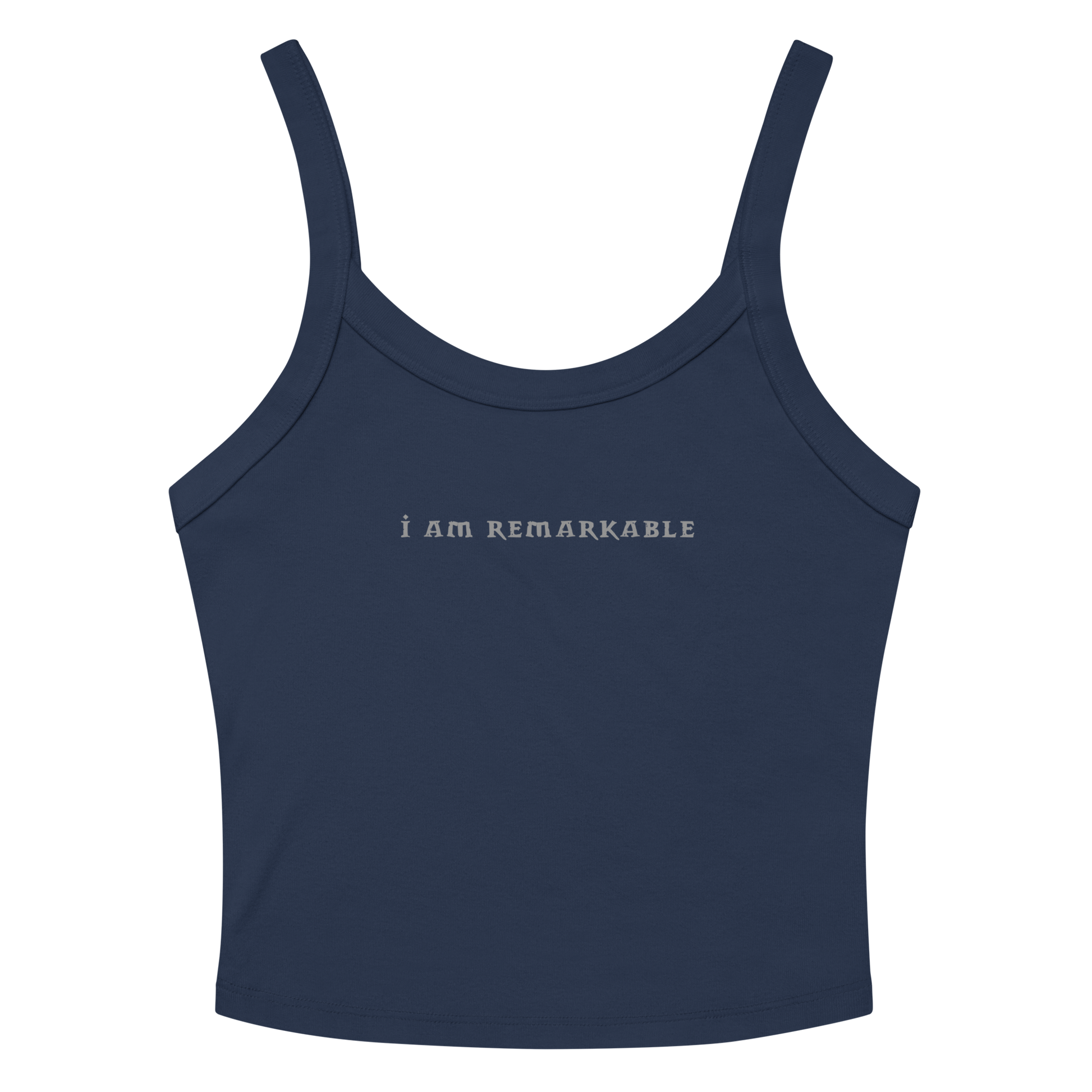 "I am remarkable" printed on a solid navy blend women's micro-rib tanktop laying on a flat surface amongst sunglasses and shorts