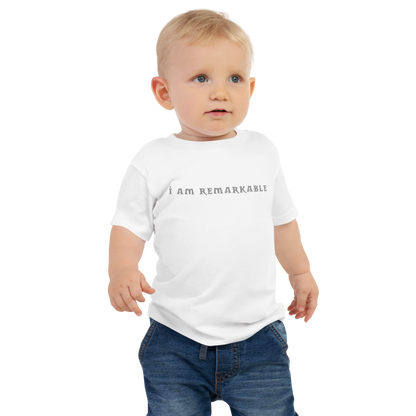 "I am remarkable" printed on a white baby jersey short sleeve tee worn by a male
