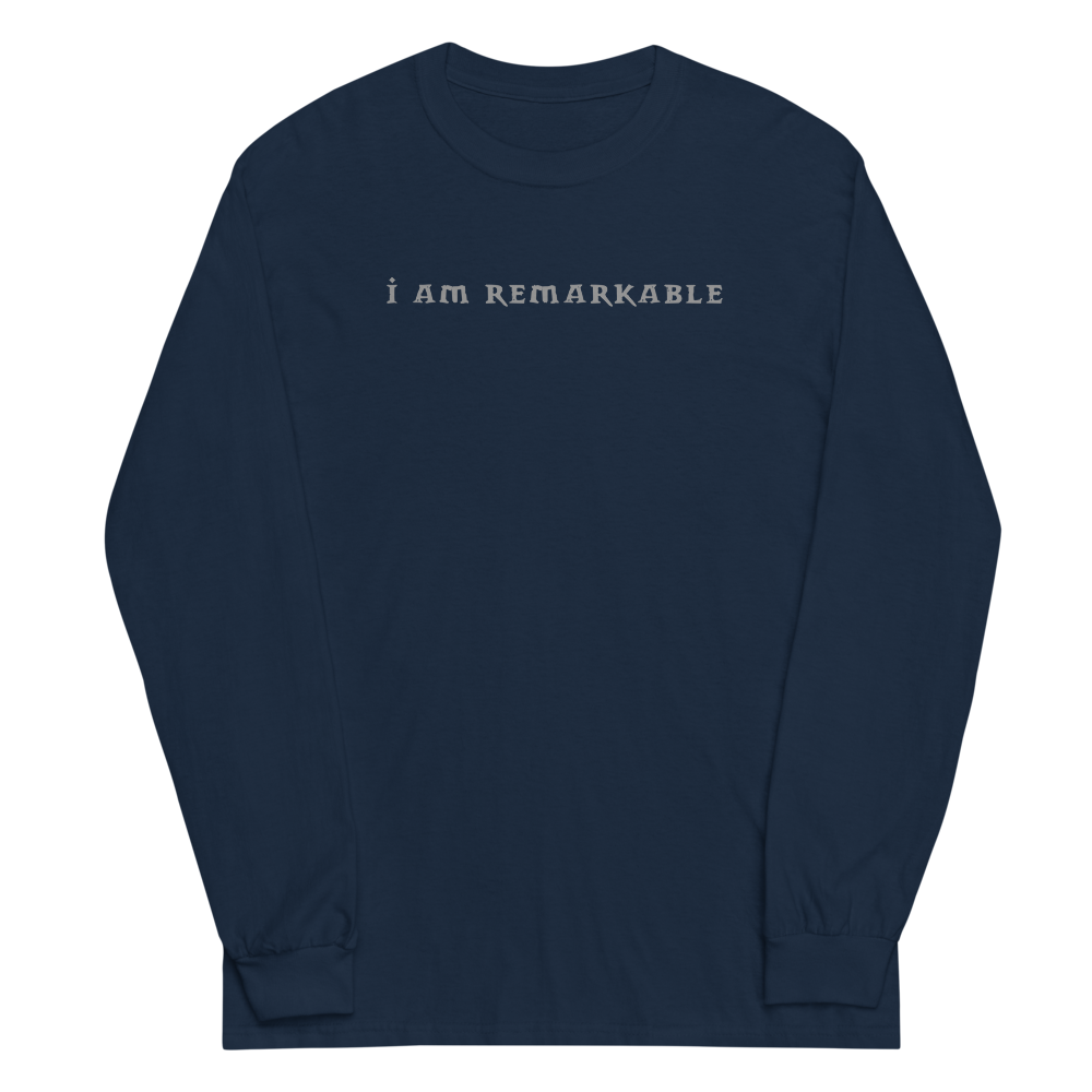 "I am remarkable" printed on a navy men's long sleeve shirt laying on a flat surface