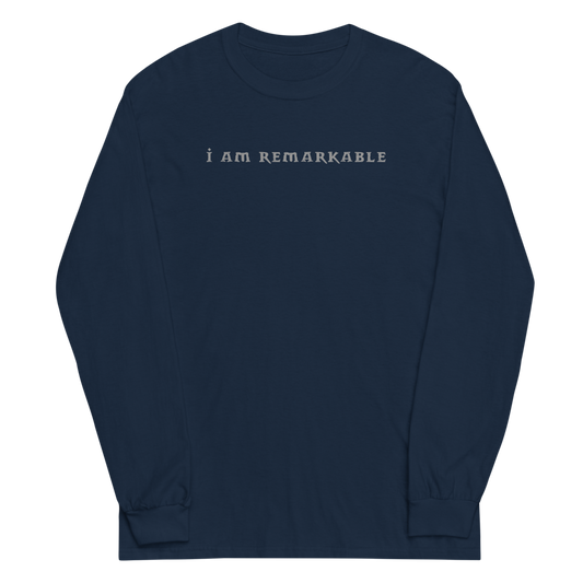 "I am remarkable" printed on a navy men's long sleeve shirt laying on a flat surface